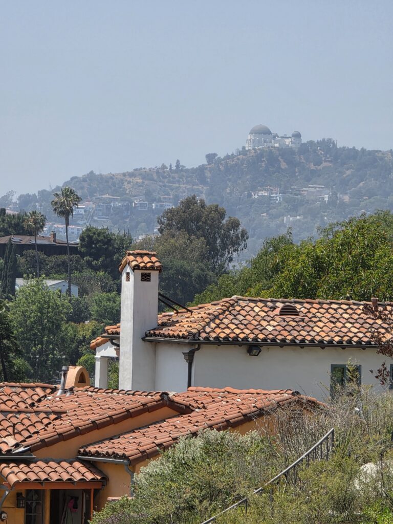 Spanish tile roof and chimney with Silver Lake hillside homes beyond
