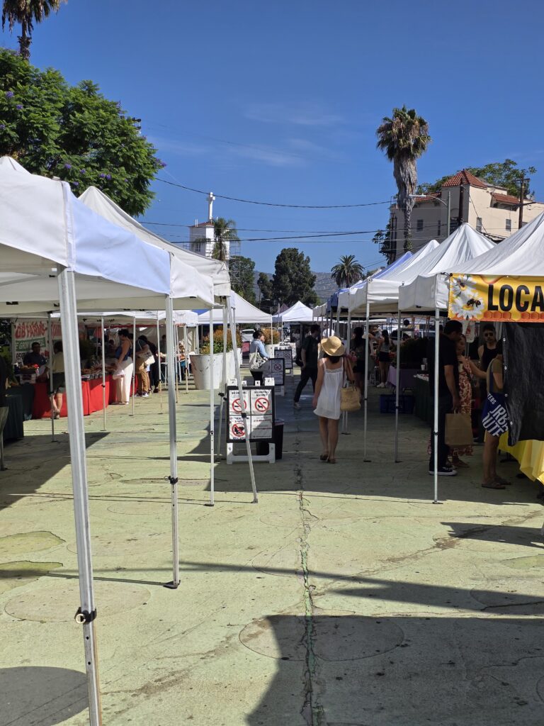 Inside the Farmers Market at Sunset Triangle Plaza with a vendors and fruits and vegatables