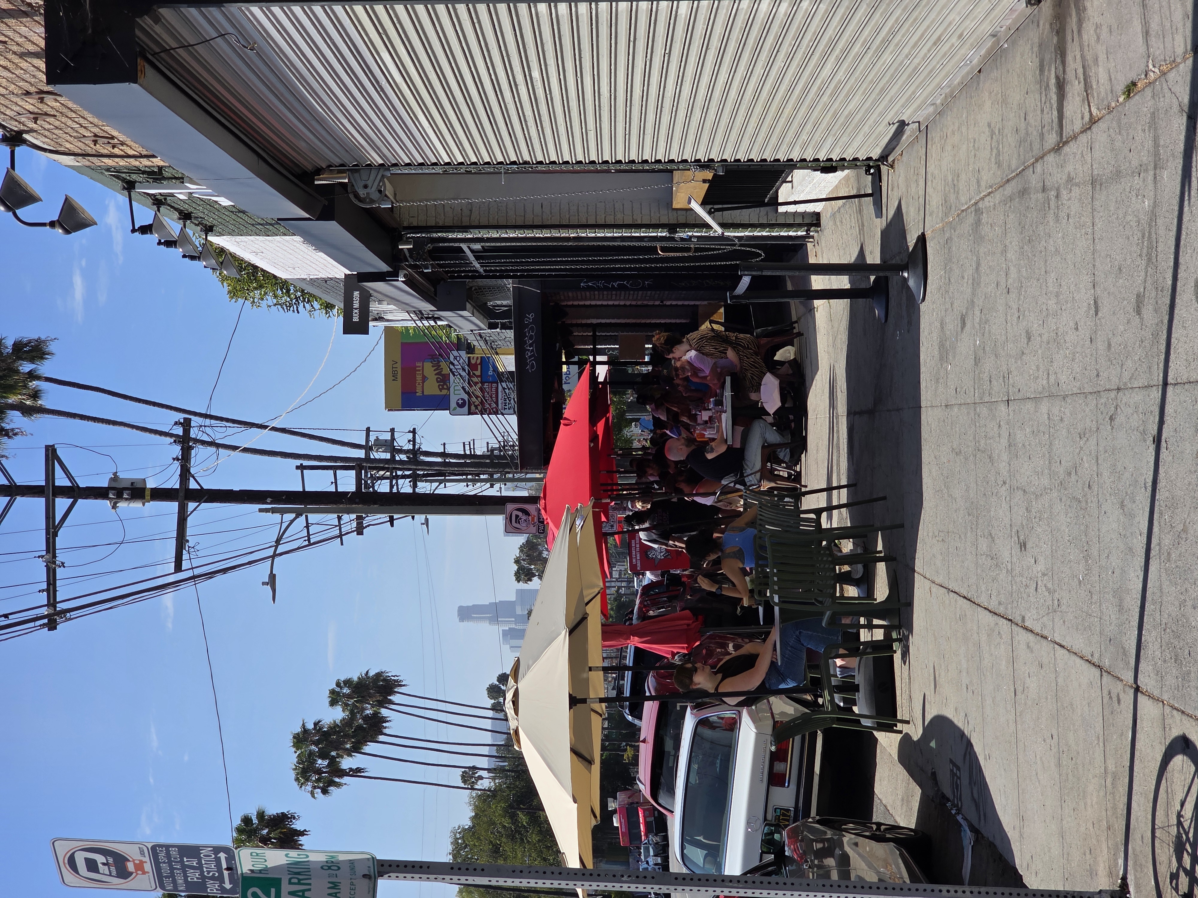 Sidewalk dining in Silver lake Blvd restaurants packed on a Saturday morning across from the Farmers Market