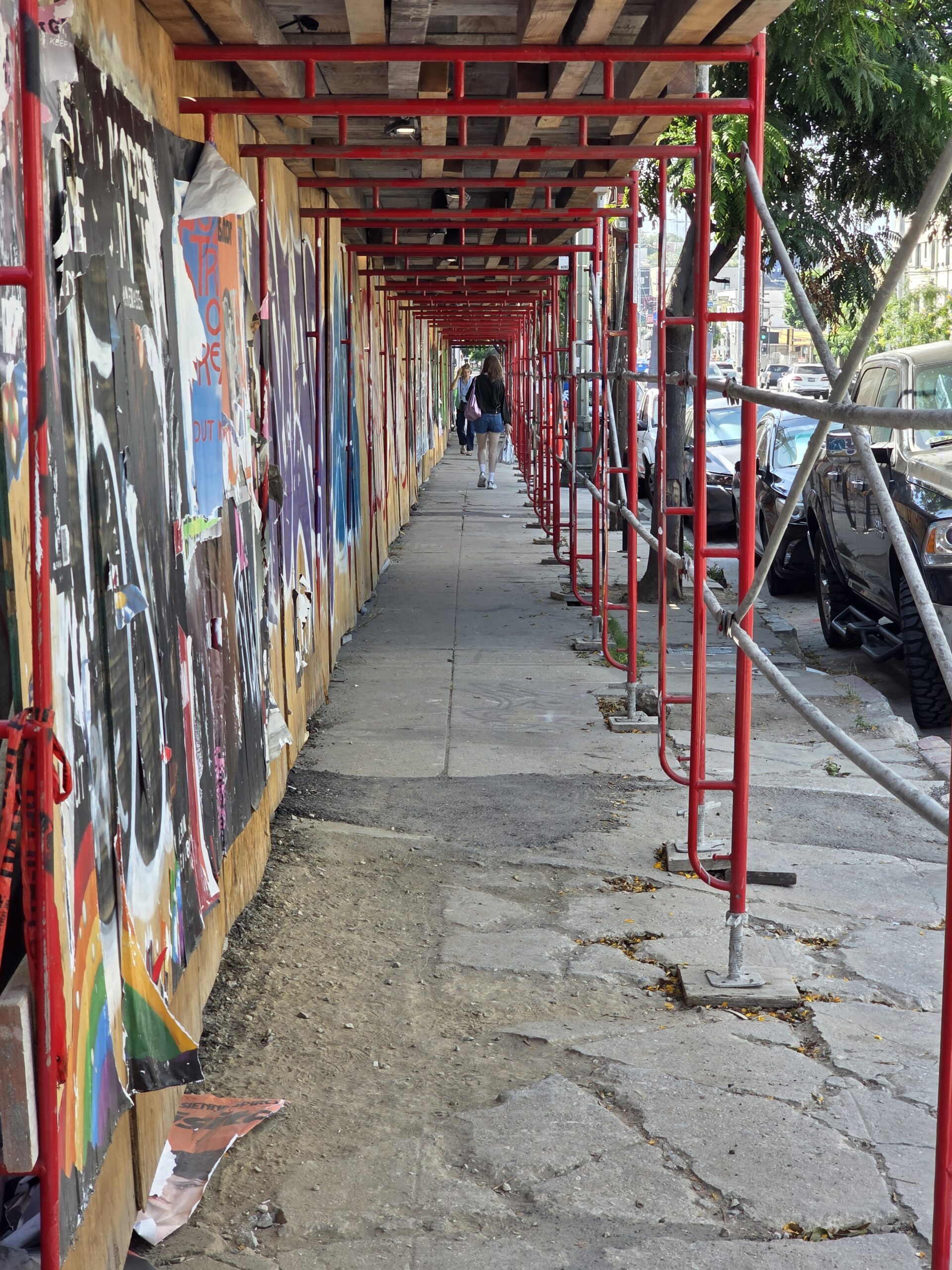 Silver Lake sidewalk with scaffolding and graffiti outside a new development