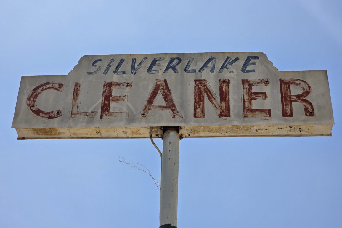Silver Lake Cleaners vintage sign that hovers high over the business seen from Silver lake Blvd