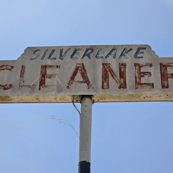 Silver Lake Cleaners vintage sign that hovers high over the business seen from Silver lake Blvd
