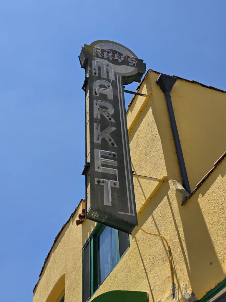 Ray's neon market sign from the 1940's era with historic staple of Mt. Washington's very small business area