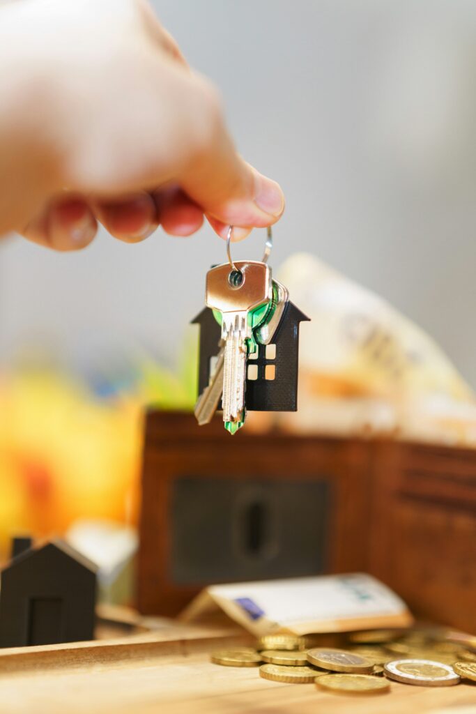 hand holding new house door keys wallet money price real estate market